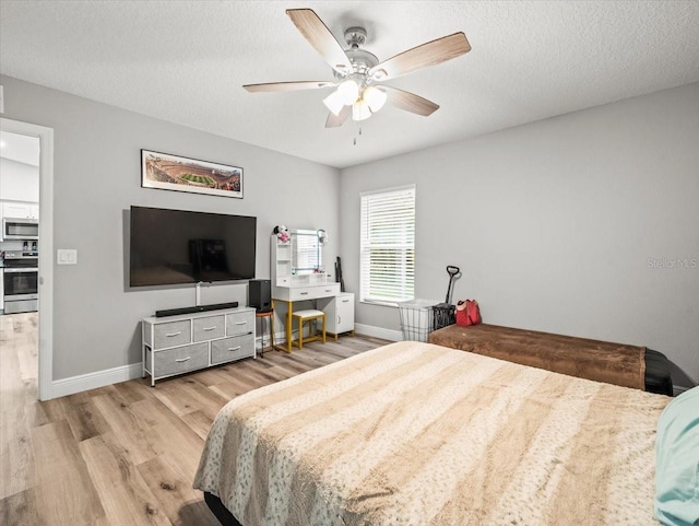 8737 N Spikes Way, Dunnellon, FL 34434 - bedroom with wood finished floors, ceiling fan, and a textured ceiling