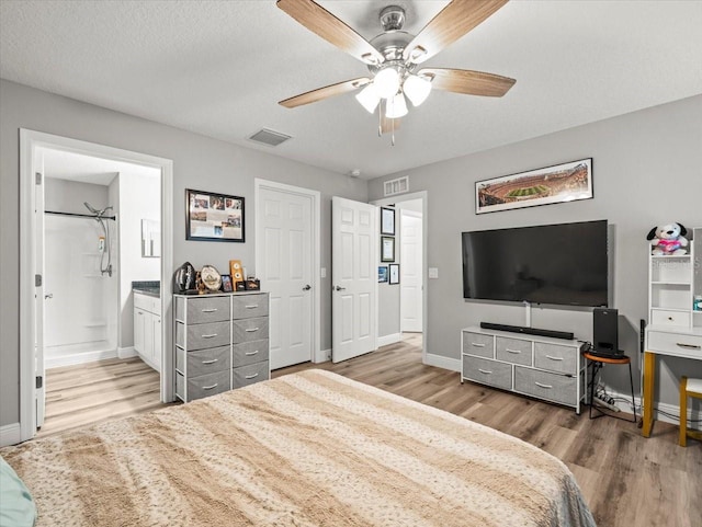 8737 N Spikes Way, Dunnellon, FL 34434 - bedroom with wood finished floors, ensuite bath, and ceiling fan