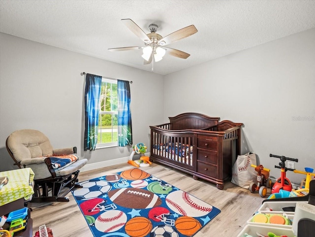 8737 N Spikes Way, Dunnellon, FL 34434 - bedroom featuring wood finished floors, a ceiling fan, and a textured ceiling