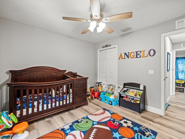 8737 N Spikes Way, Dunnellon, FL 34434 - bedroom with wood finished floors, a ceiling fan, and attic access