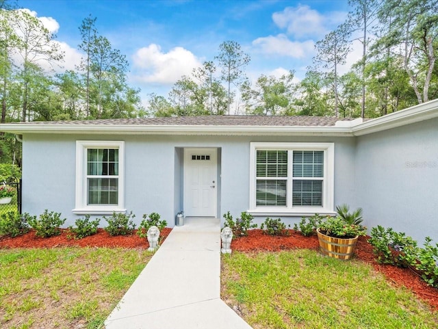8737 N Spikes Way, Dunnellon, FL 34434 - entrance to property featuring stucco siding and a yard