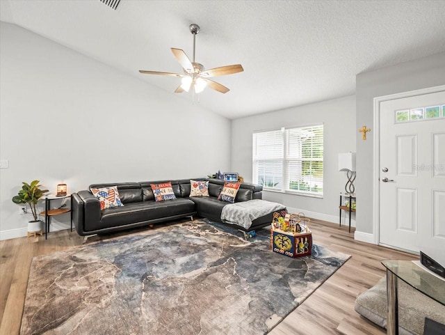 8737 N Spikes Way, Dunnellon, FL 34434 - living room featuring plenty of natural light, a ceiling fan, wood finished floors, and lofted ceiling