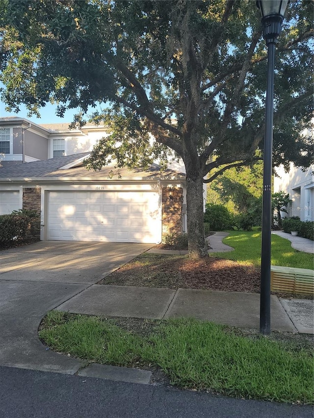 19239 Stone Hedge Dr, Tampa, FL 33647 - view of front of property featuring an attached garage, driveway, and stucco siding