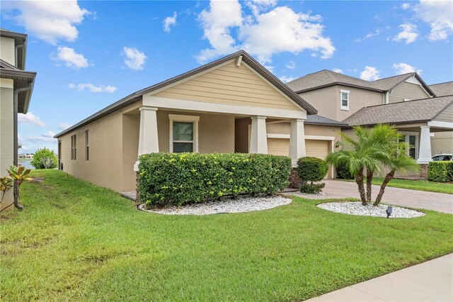11308 Chilly Water Ct, Riverview, FL 33569 - view of front of property with stucco siding, a garage, a front lawn, and decorative driveway