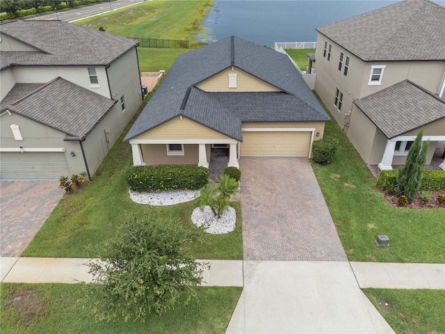 11308 Chilly Water Ct, Riverview, FL 33569 - view of front of house featuring decorative driveway, a garage, a front lawn, stucco siding, and a shingled roof