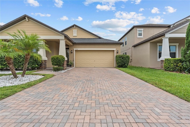 11308 Chilly Water Ct, Riverview, FL 33569 - view of front of property with decorative driveway, stucco siding, an attached garage, and a front yard