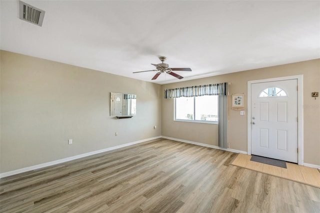 8396 111th St Unit 301, Seminole, FL 33772 - foyer entrance featuring light wood-type flooring, healthy amount of natural light, and a ceiling fan