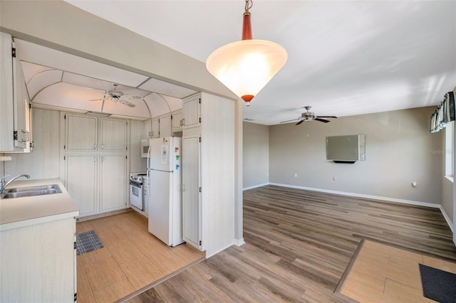 8396 111th St Unit 301, Seminole, FL 33772 - kitchen with ceiling fan, white appliances, light wood-style floors, and light countertops