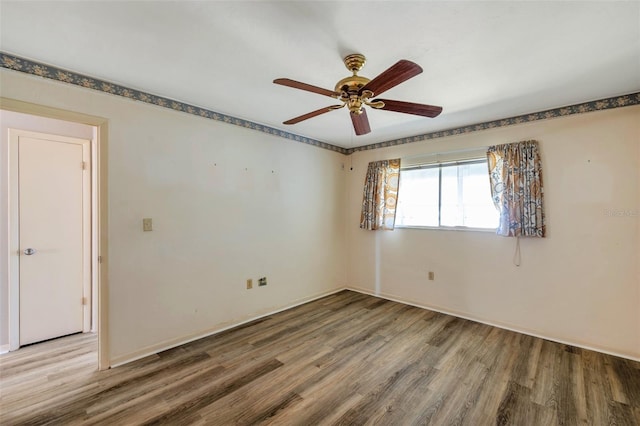 8396 111th St Unit 301, Seminole, FL 33772 - empty room featuring wood finished floors and ceiling fan