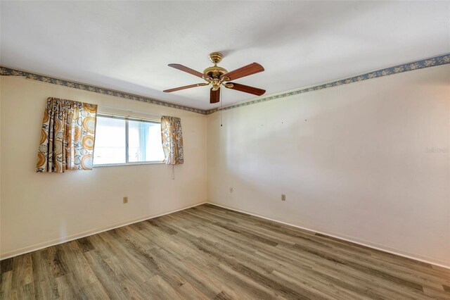 8396 111th St Unit 301, Seminole, FL 33772 - unfurnished room featuring wood finished floors and ceiling fan