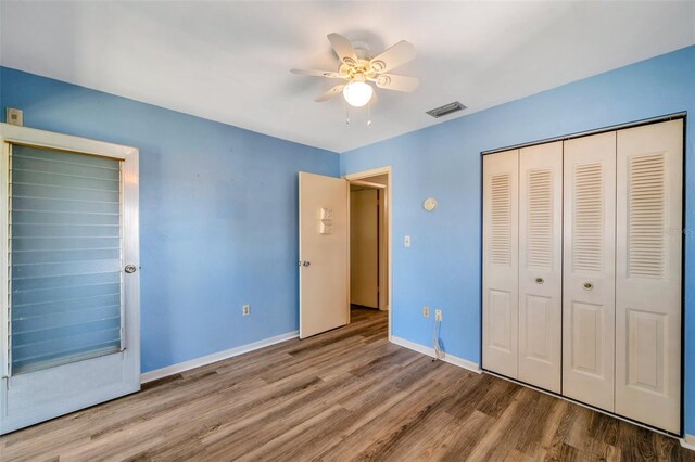 8396 111th St Unit 301, Seminole, FL 33772 - unfurnished bedroom featuring wood finished floors, a closet, and a ceiling fan