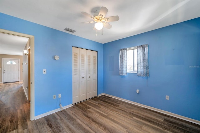 8396 111th St Unit 301, Seminole, FL 33772 - unfurnished bedroom with wood finished floors, a closet, and a ceiling fan