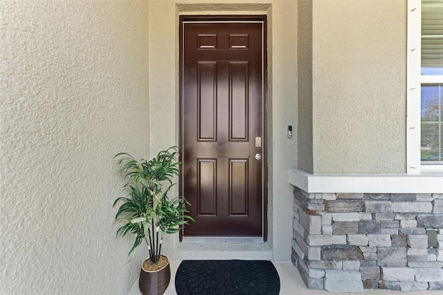 8050 Praise Dr, Tampa, FL 33625 - entrance to property with stucco siding and stone siding