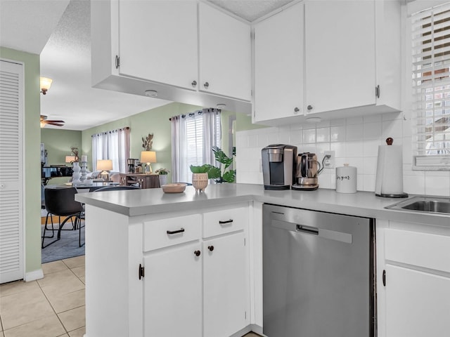 1250 S Pinellas Ave Unit 207, Tarpon Springs, FL 34689 - kitchen with stainless steel dishwasher, open floor plan, a peninsula, light countertops, and decorative backsplash