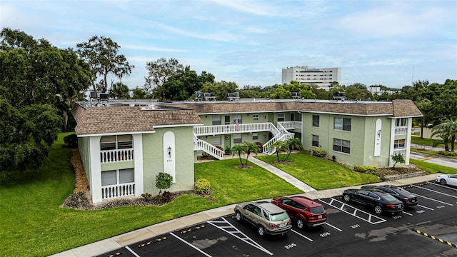 1250 S Pinellas Ave Unit 207, Tarpon Springs, FL 34689 - view of property with uncovered parking and stairs