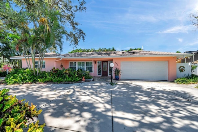3898 49th Ave S, Saint Petersburg, FL 33711 - ranch-style home with stucco siding, an attached garage, and concrete driveway