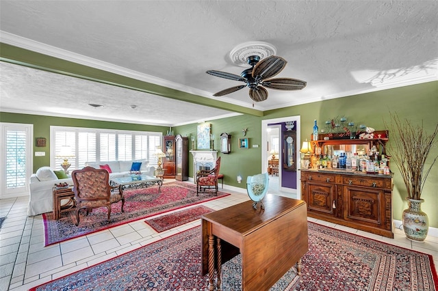 3898 49th Ave S, Saint Petersburg, FL 33711 - tiled living room featuring a textured ceiling, ceiling fan, crown molding, and a dry bar