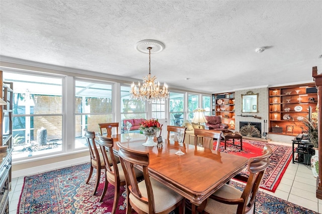 3898 49th Ave S, Saint Petersburg, FL 33711 - dining space featuring healthy amount of natural light, a textured ceiling, a chandelier, light tile patterned flooring, and a brick fireplace