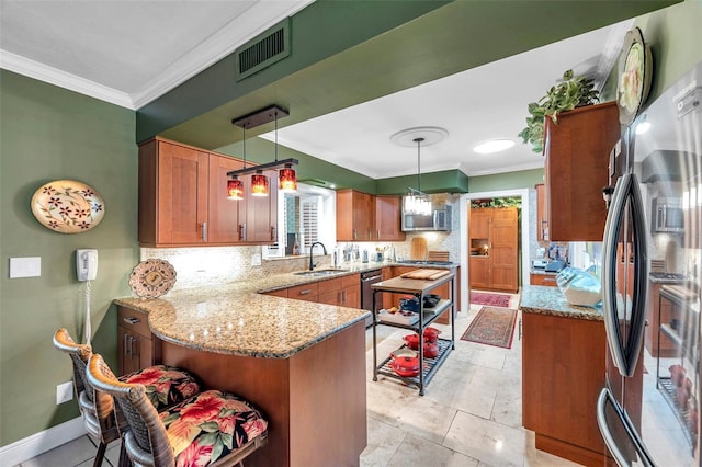 3898 49th Ave S, Saint Petersburg, FL 33711 - kitchen with appliances with stainless steel finishes, a peninsula, crown molding, tasteful backsplash, and light stone countertops