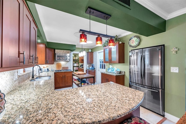 3898 49th Ave S, Saint Petersburg, FL 33711 - kitchen with stainless steel appliances, crown molding, tasteful backsplash, a peninsula, and light stone counters