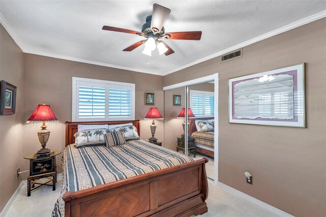 3898 49th Ave S, Saint Petersburg, FL 33711 - bedroom with light carpet, multiple windows, a closet, crown molding, and ceiling fan