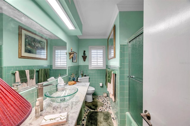 3898 49th Ave S, Saint Petersburg, FL 33711 - bathroom featuring tile walls, crown molding, vanity, and wainscoting