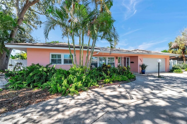 3898 49th Ave S, Saint Petersburg, FL 33711 - ranch-style house featuring a garage, stucco siding, and concrete driveway