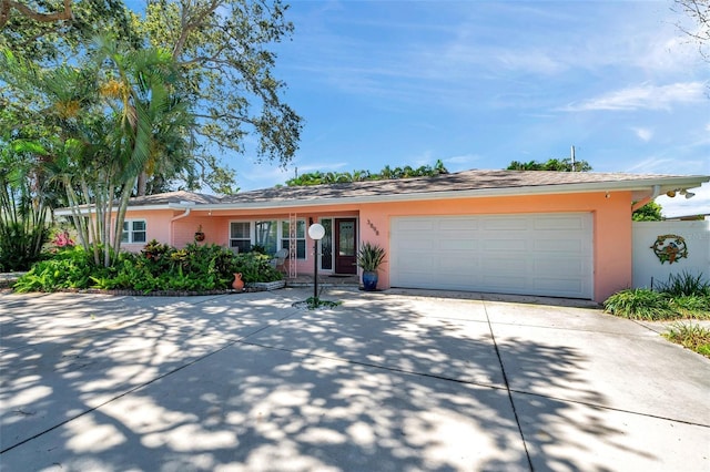 3898 49th Ave S, Saint Petersburg, FL 33711 - single story home with stucco siding, concrete driveway, and a garage