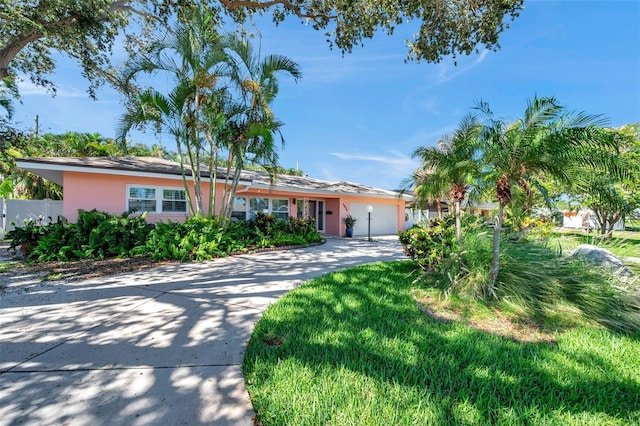 3898 49th Ave S, Saint Petersburg, FL 33711 - ranch-style house with a garage, driveway, and stucco siding
