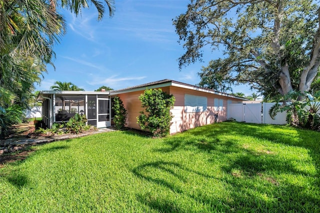 3898 49th Ave S, Saint Petersburg, FL 33711 - back of property with a sunroom and a gate