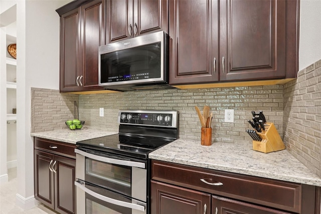 5808 Grand Sonata Ave, Lutz, FL 33558 - kitchen with appliances with stainless steel finishes, tasteful backsplash, light stone counters, and dark brown cabinets