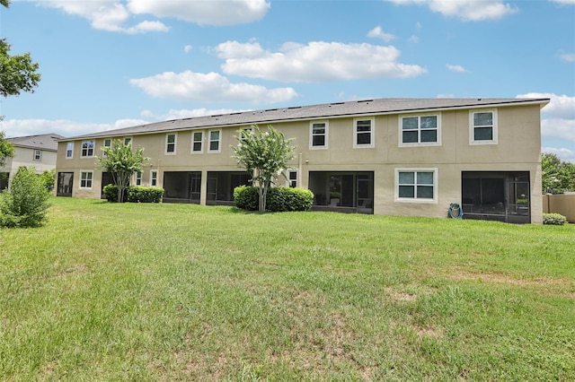 5808 Grand Sonata Ave, Lutz, FL 33558 - back of house with stucco siding, a sunroom, and a yard
