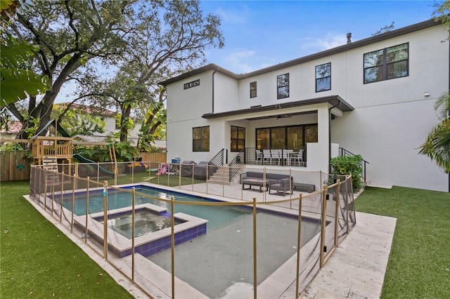 503 W Davis Blvd, Tampa, FL 33606 - back of property with stucco siding, ceiling fan, a patio, and a pool with connected hot tub
