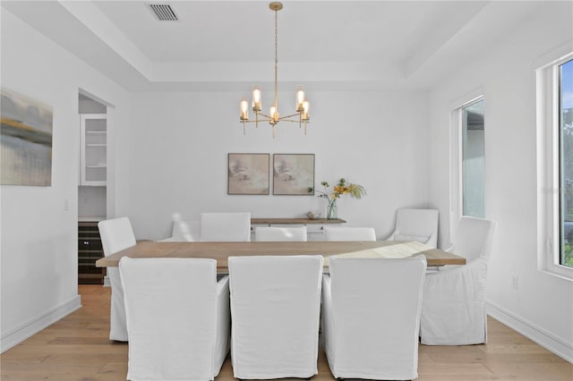 503 W Davis Blvd, Tampa, FL 33606 - dining room featuring a raised ceiling, a chandelier, and light wood finished floors