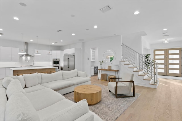 503 W Davis Blvd, Tampa, FL 33606 - living room featuring wine cooler, stairway, light wood-style floors, recessed lighting, and french doors
