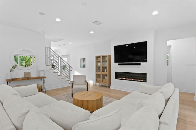 503 W Davis Blvd, Tampa, FL 33606 - living room featuring stairway, recessed lighting, light wood-style floors, and a glass covered fireplace