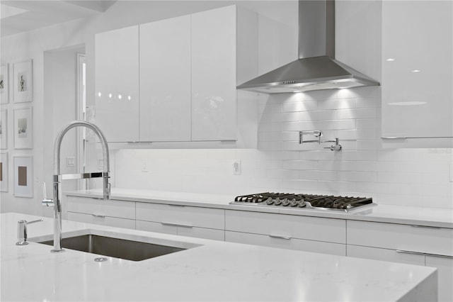 503 W Davis Blvd, Tampa, FL 33606 - kitchen featuring wall chimney exhaust hood, stainless steel gas stovetop, modern cabinets, and white cabinets