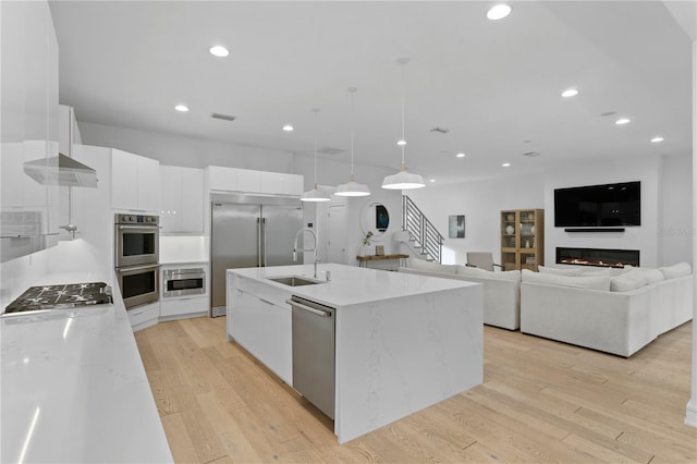 503 W Davis Blvd, Tampa, FL 33606 - kitchen with built in appliances, modern cabinets, white cabinets, recessed lighting, and decorative light fixtures