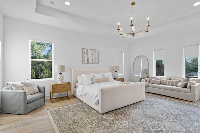 503 W Davis Blvd, Tampa, FL 33606 - bedroom with a chandelier, a tray ceiling, multiple windows, light wood finished floors, and recessed lighting