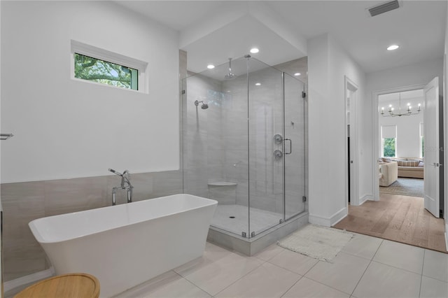 503 W Davis Blvd, Tampa, FL 33606 - ensuite bathroom with a freestanding tub, a shower stall, tile patterned flooring, a chandelier, and recessed lighting