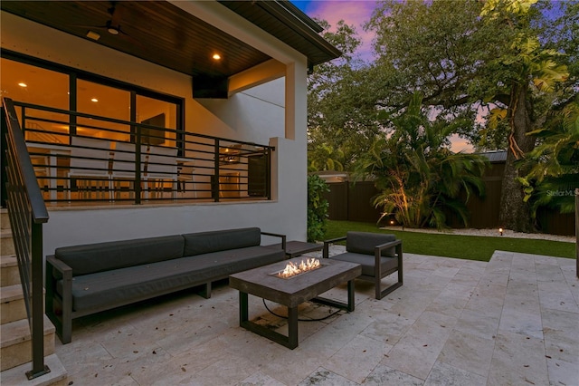 503 W Davis Blvd, Tampa, FL 33606 - patio terrace at dusk with a patio area, a fenced backyard, and an outdoor living space with a fire pit