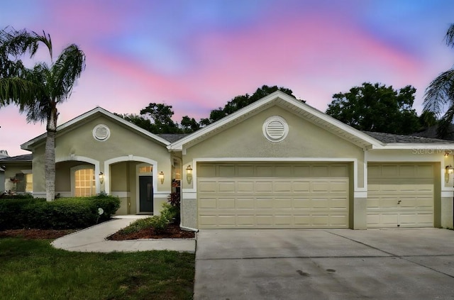 15217 Octavia Ln, Odessa, FL 33556 - ranch-style house featuring an attached garage, concrete driveway, and stucco siding
