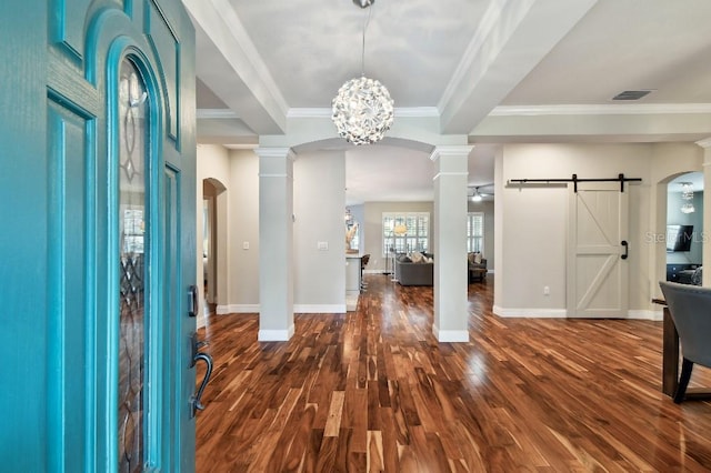 15217 Octavia Ln, Odessa, FL 33556 - entryway with a barn door, dark wood-style floors, crown molding, arched walkways, and a chandelier