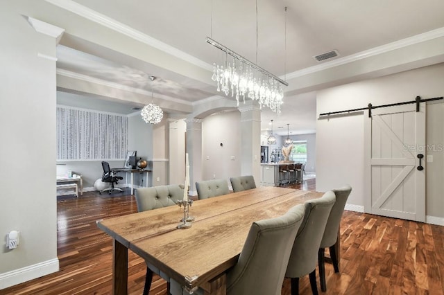 15217 Octavia Ln, Odessa, FL 33556 - dining room featuring decorative columns, a barn door, wood finished floors, a chandelier, and ornamental molding
