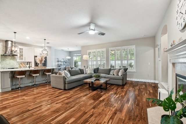 15217 Octavia Ln, Odessa, FL 33556 - living area featuring dark wood-style floors, healthy amount of natural light, a tiled fireplace, and ceiling fan