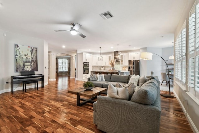 15217 Octavia Ln, Odessa, FL 33556 - living area with ceiling fan, ornate columns, dark wood-style flooring, arched walkways, and recessed lighting