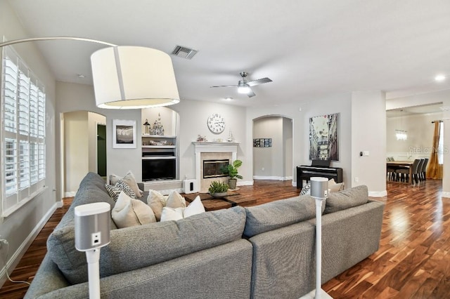 15217 Octavia Ln, Odessa, FL 33556 - living area with arched walkways, a ceiling fan, dark wood-style flooring, and recessed lighting