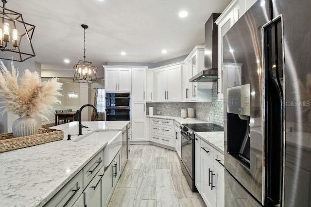 15217 Octavia Ln, Odessa, FL 33556 - kitchen featuring black appliances, wall chimney range hood, a chandelier, tasteful backsplash, and recessed lighting
