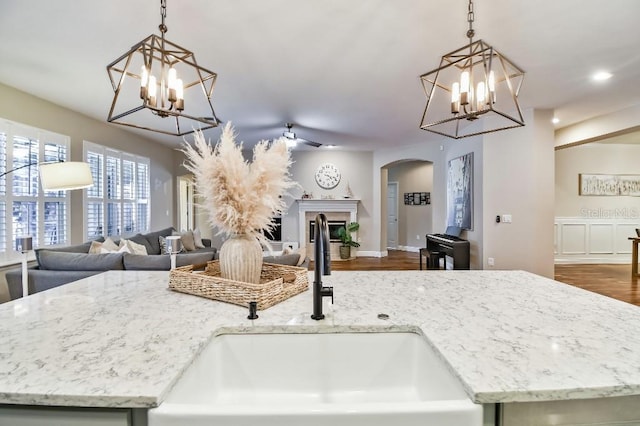 15217 Octavia Ln, Odessa, FL 33556 - kitchen with open floor plan, a chandelier, arched walkways, dark wood-style flooring, and recessed lighting