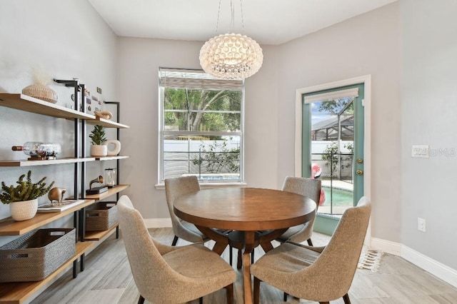 15217 Octavia Ln, Odessa, FL 33556 - dining space featuring a chandelier, wood finished floors, and plenty of natural light